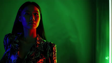 stylish woman illuminated by vibrant neon lights
