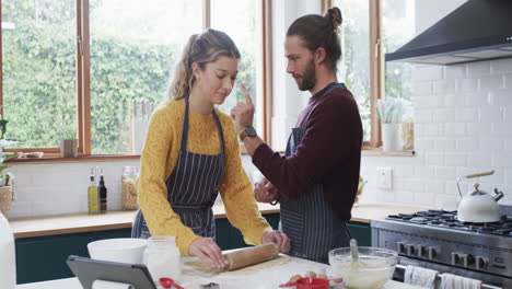 Happy-diverse-couple-spending-time-together-at-home-at-christmas,-in-slow-motion