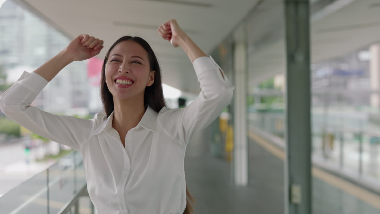 Excited Asian Businesswoman Celebrating Success in the City