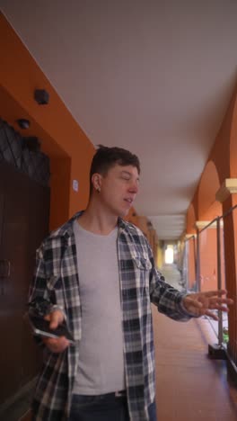 man walking in an architectural corridor