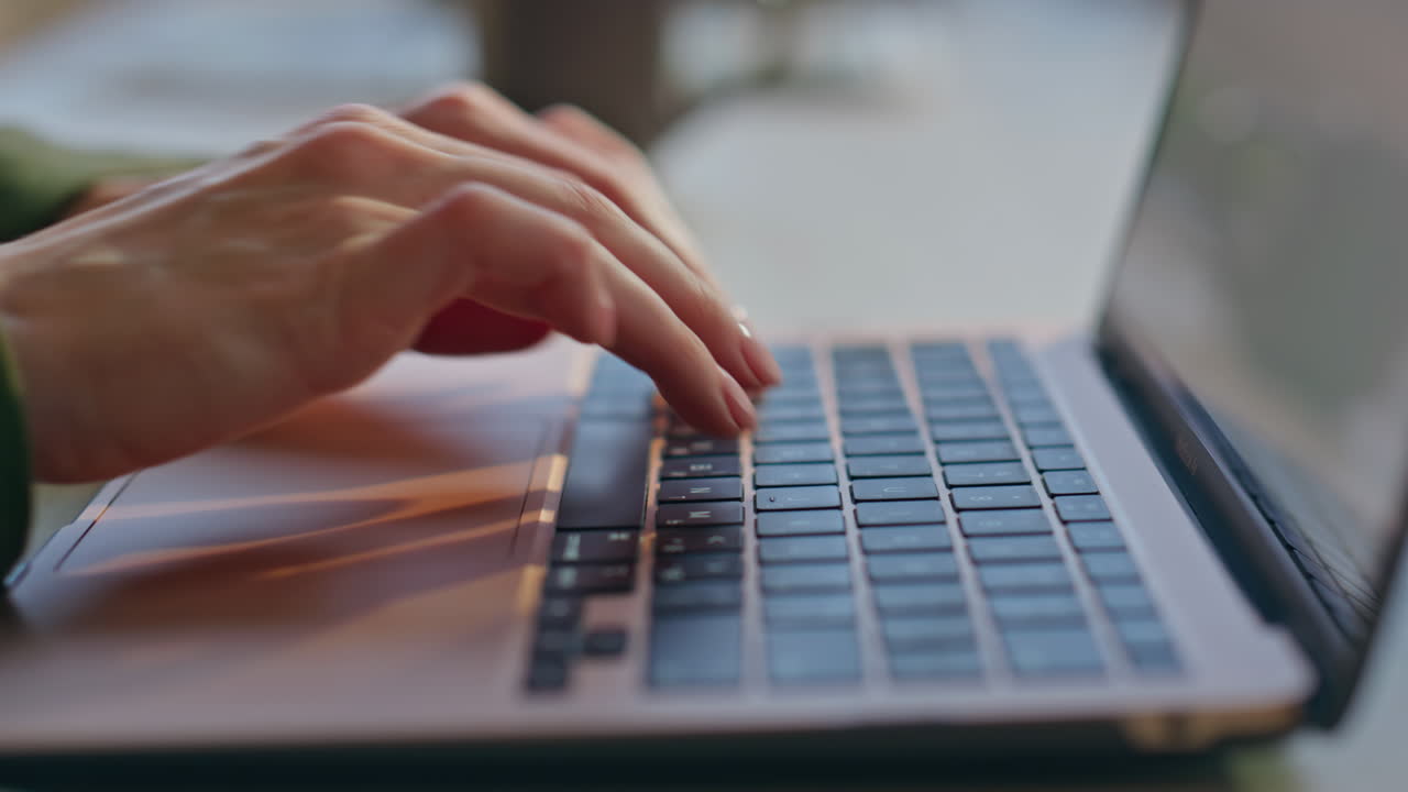 Woman fingers pressing laptop in office closeup. Businesswoman hands working