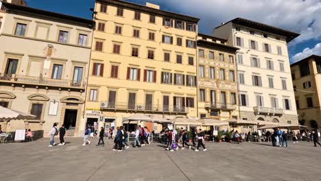 people walking in a historic town square