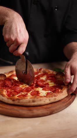 pizza being cut by a chef