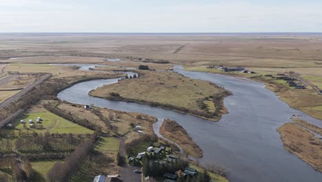 Ytri-Rangá-Ranga-river-flowing-in-flat-landscape-of-South-Iceland,-aerial