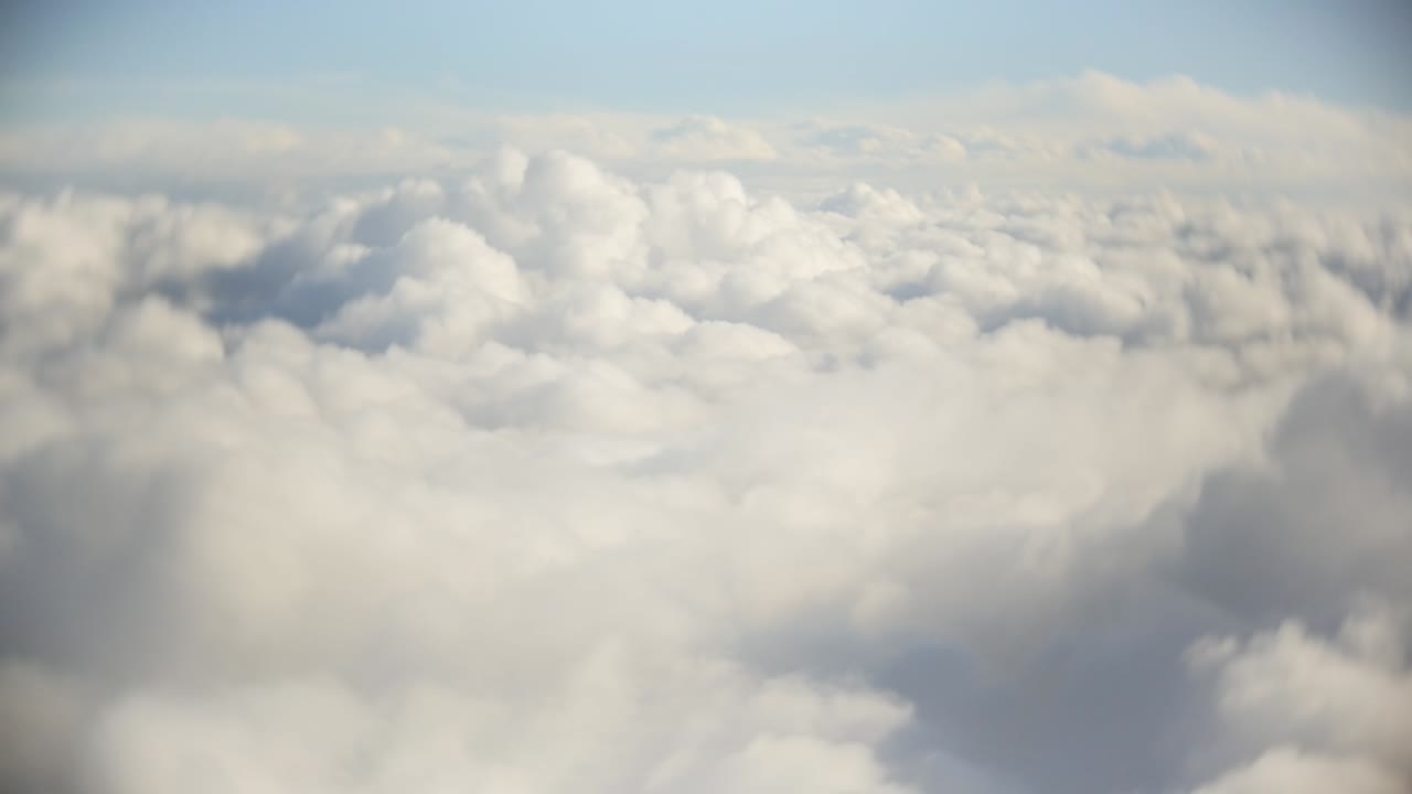 Flight over clouds, a view from a plane window - beautiful blue sky