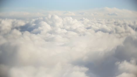 Flight-over-clouds,-a-view-from-a-plane-window---beautiful-blue-sky