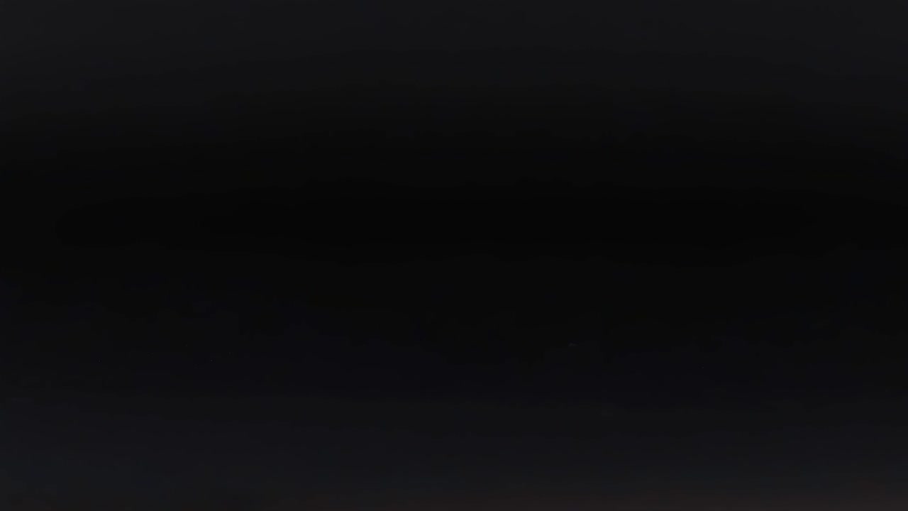 A pink sphere shifts position on a dark surface, creating a dynamic visual sequence.