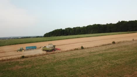 a cinematic 4k drone shot of two tractors working on a field in france, showcasing agriculture