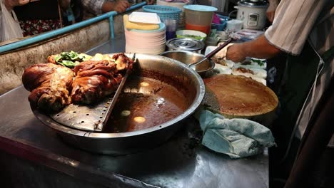 popular saturday night market street food in chiang mai, thailand. juicy thai pork street food cooked fresh. a lively and fun night market