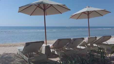 sun-beds-and-umbrellas-in-Gili-Trawangan-beach,-Bali,-Indonesia