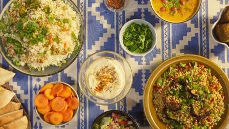 putting cooked bulgur and couscous with chicken top view. arabian cuisine. pita, hummus and vegetable salad. traditional middle eastern culture. delicious rice with meat. homemade food concept