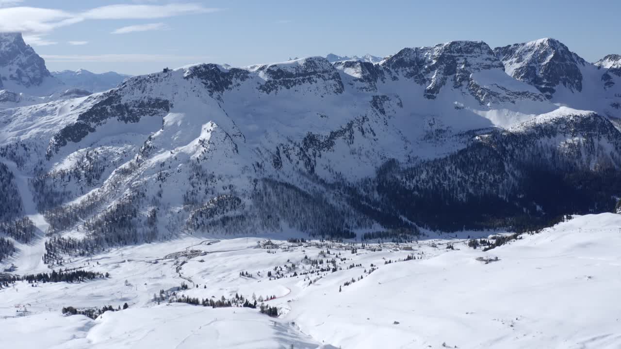 toma panorámica de drones de la hermosa cordillera italiana nevada durante el tiempo soleado con cielo azul y algunas nubes