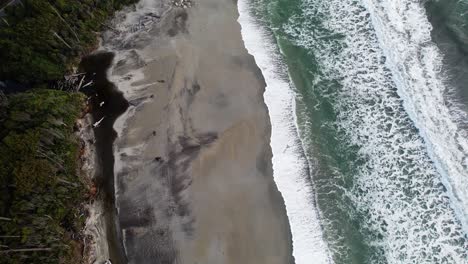 bird's eye view over maori beach in bruce bay, new zealand - drone shot
