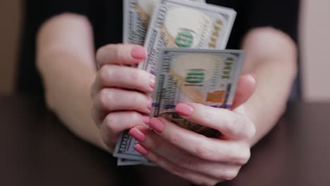 dólares en las manos de una mujer, la chica cuenta billetes, dinero de papel. presupuesto familiar, pago de facturas