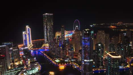 aerial slide and pan footage of modern buildings at marina