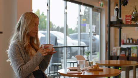 young woman having coffee in cafe 4k