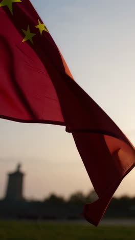 chinese flag waving in the wind at sunset