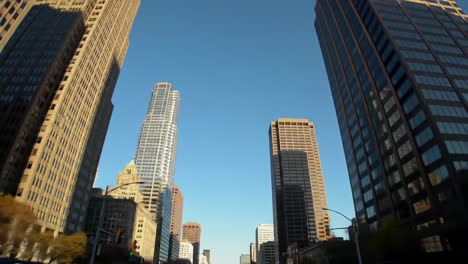 a cityscape journey through skyscrapers under a clear blue sky, capturing the essence of urban architecture and modern design in fortifying structures