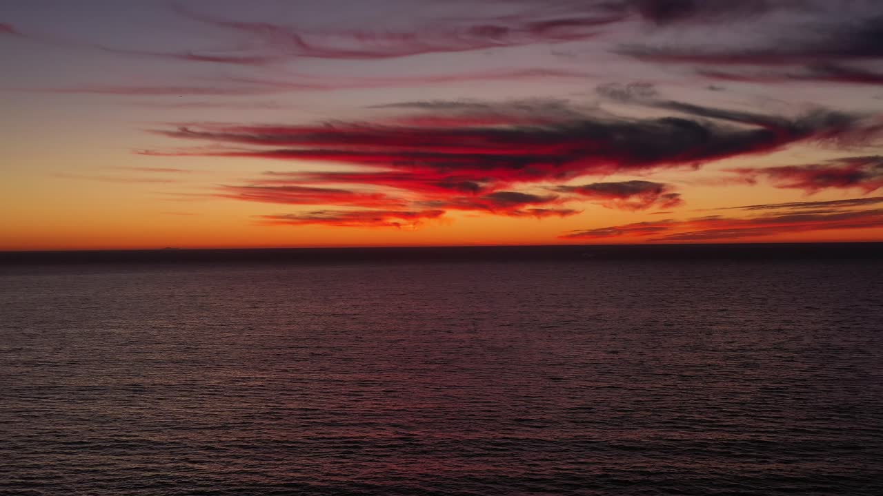 Peaceful And Inviting Orange Sunset By The Sea - aerial shot