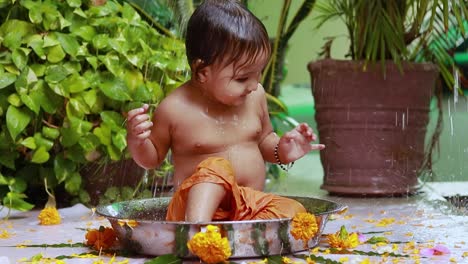 cute toddler baby boy bathing in decorated bathtub at outdoor from unique perspective