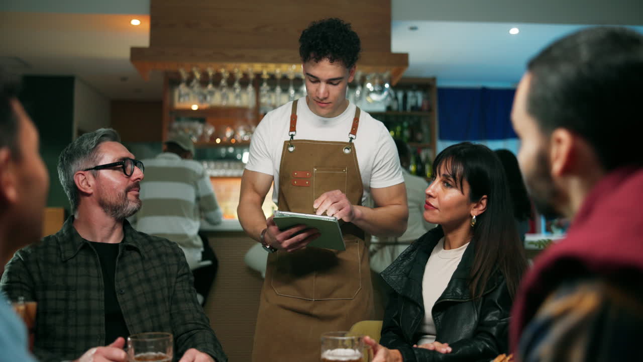 Waiter taking orders from customers at a restaurant