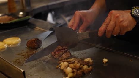 chef cooking meat and vegetables on hot grill