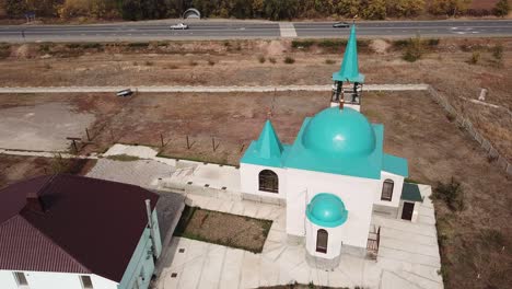 aerial: small mosque is shining in sunrise.