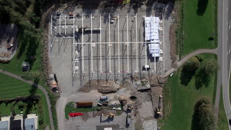 construction site with excavator and crane, aerial topdown in nordic country