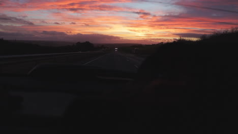 beautiful sunset seen out of the rear window of a moving car