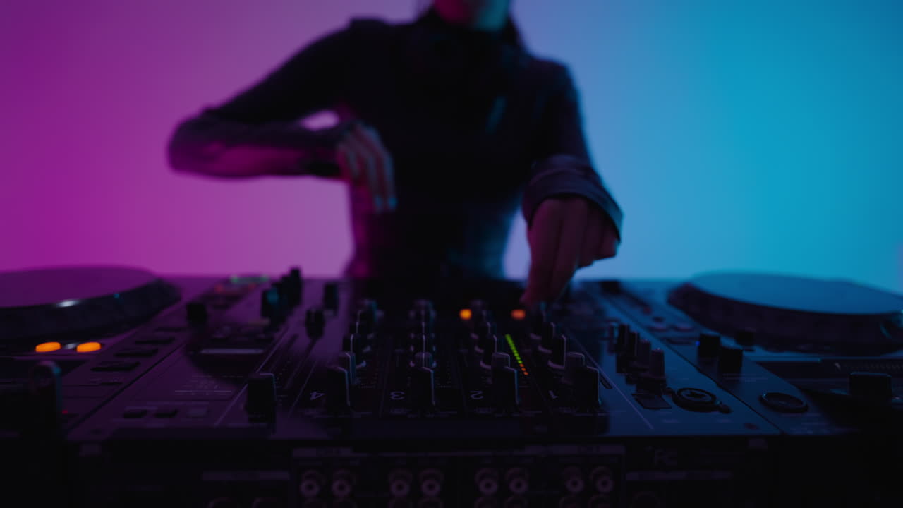 Woman dj mixing music on a mixer