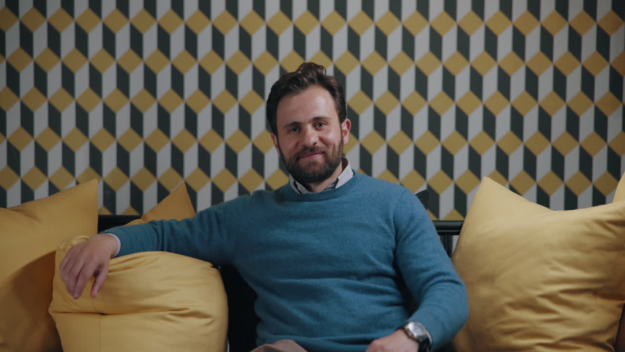 Man sitting on couch smiling