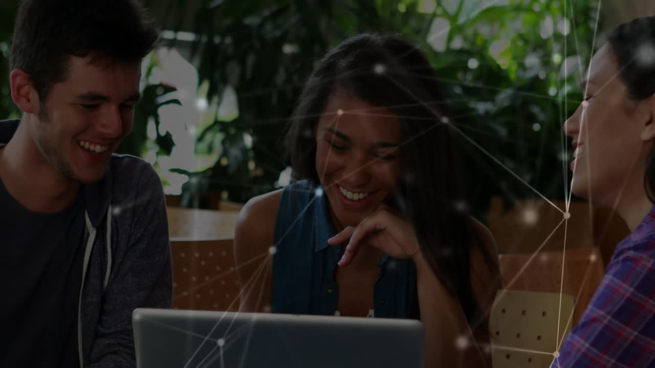 Network connections animation over diverse people laughing and using laptop
