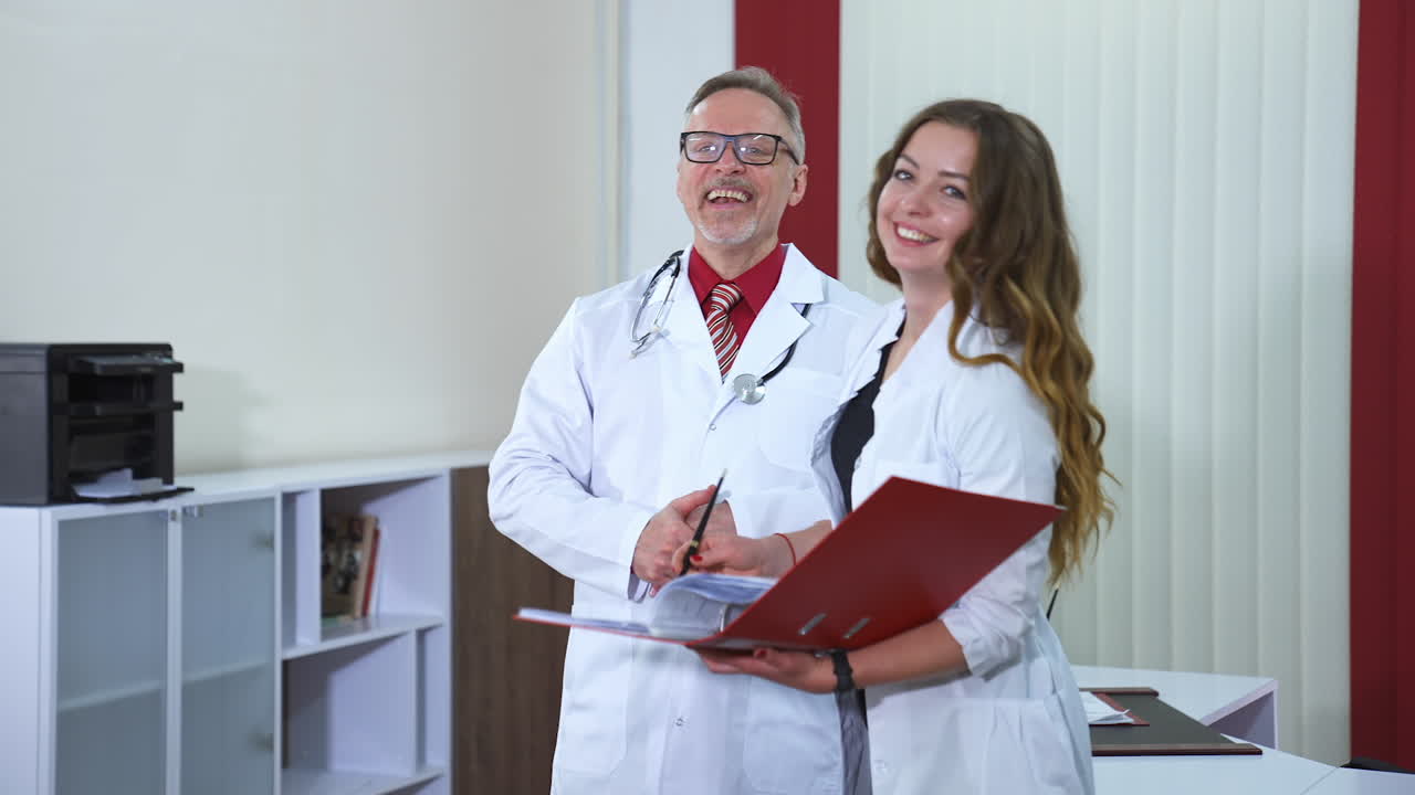 Two doctors feeling excited about healthcare treatment results. Happy solution of health isuues.