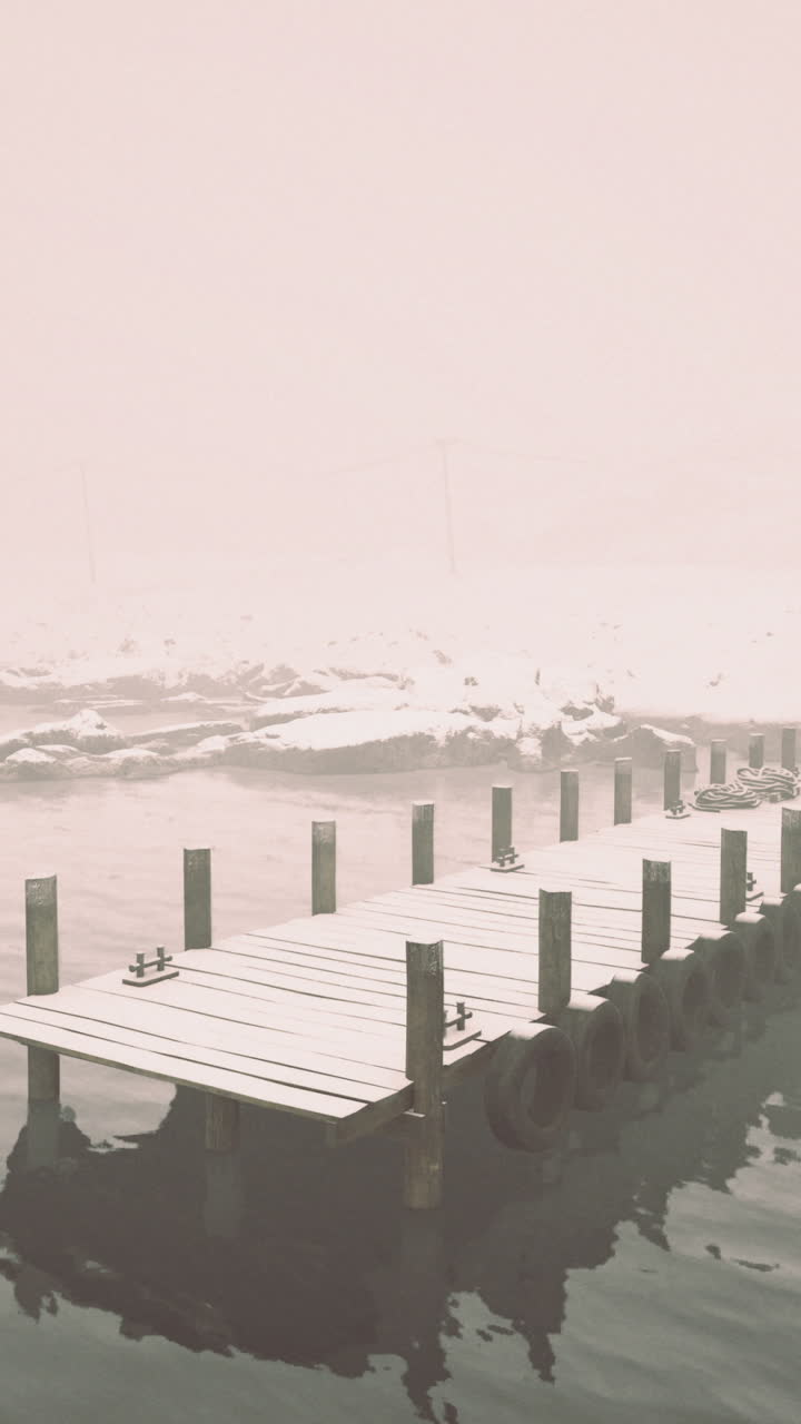 Calm winter morning by the foggy lake with a wooden dock and cabin