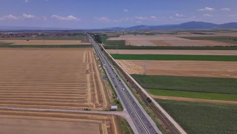 scenic footage of traffic on the e574 road, with a car moving through a rural agricultural area near brașov