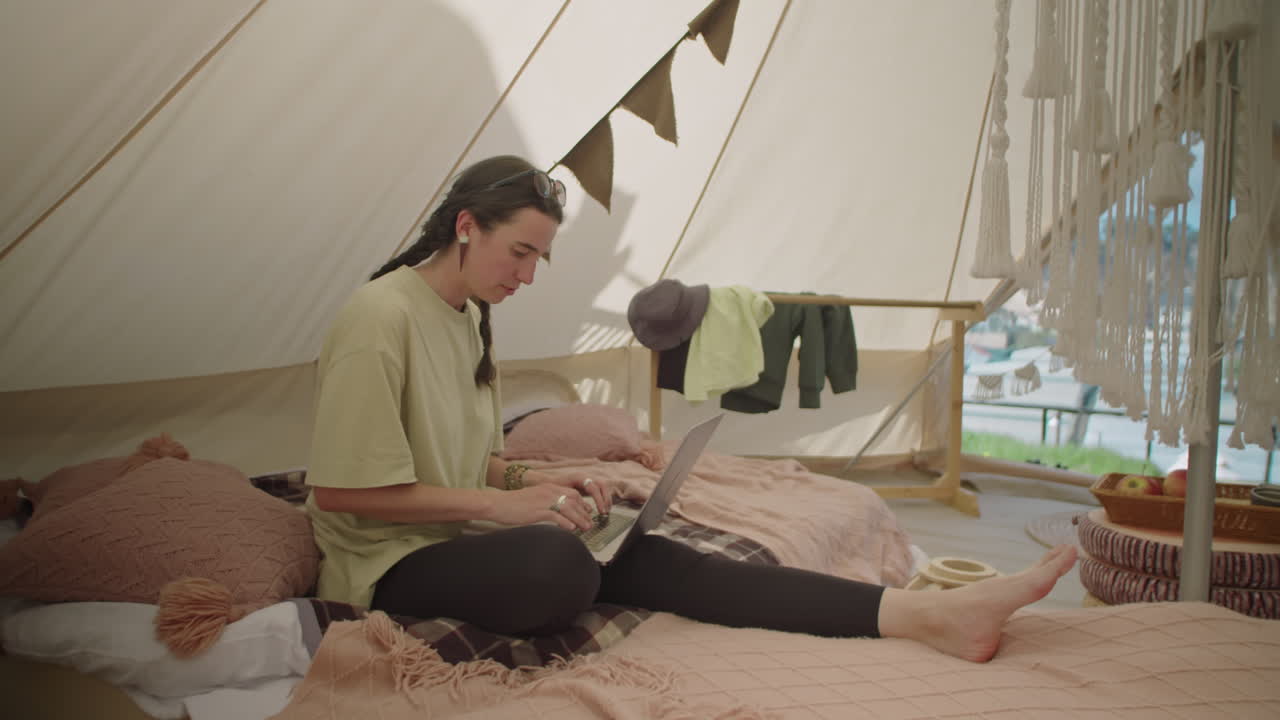 Female Tourist Working on Laptop in Glamping Tent