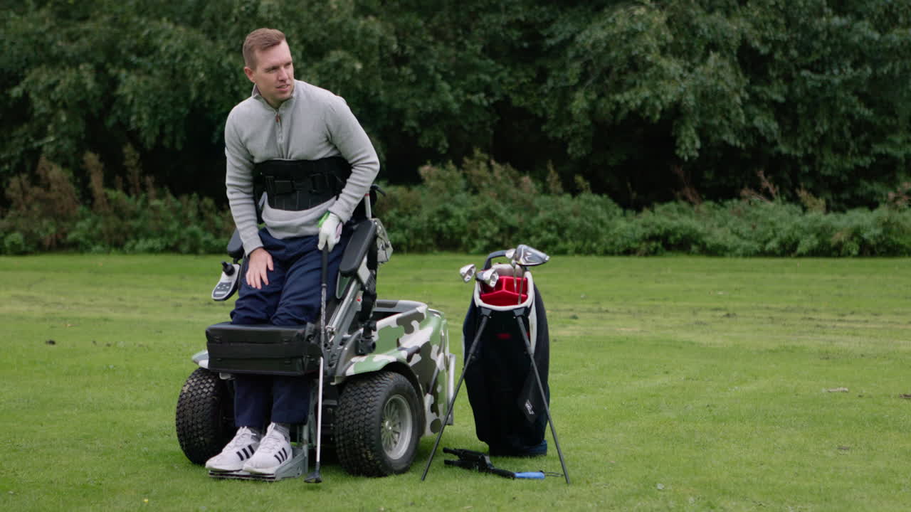 Man playing golf from a golf cart