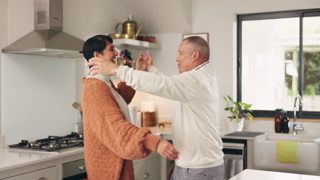 senior couple, dancing and kitchen with love