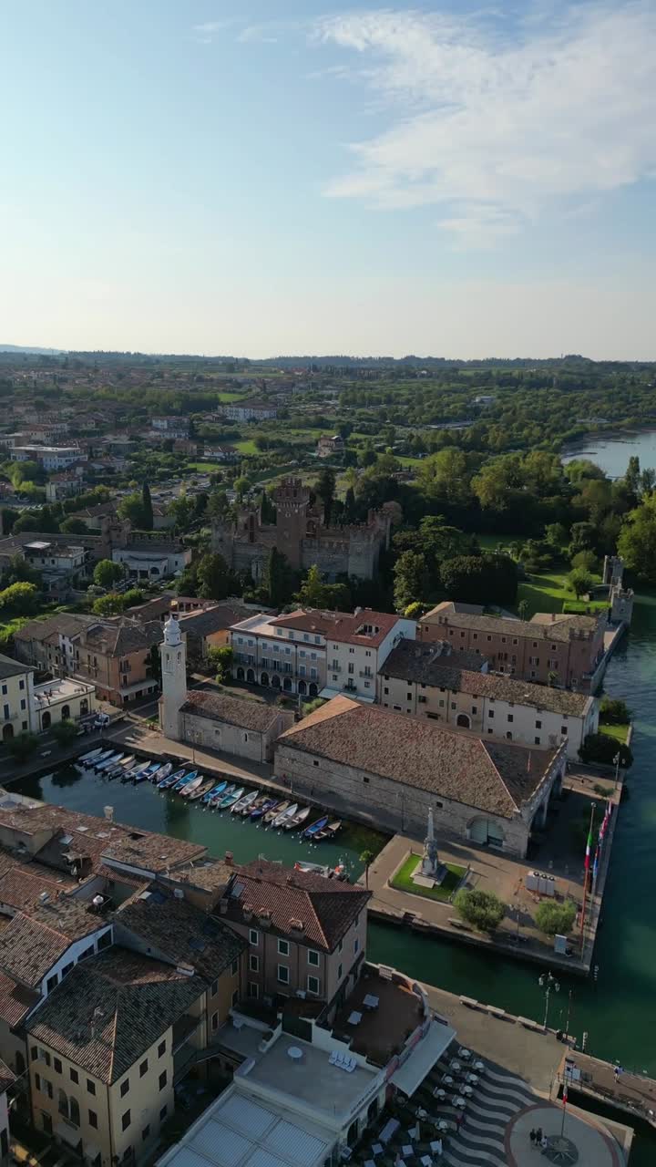 Ancient city walls harbor Scaligero Castle in Italy, shore of Lake Garda, aerial drone