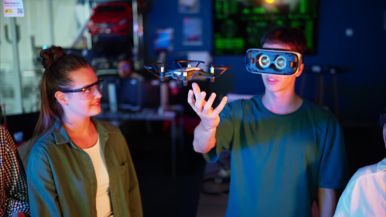 Young engineers with VR virtual reality headset controlling fliying drone in research laboratory, slow motion