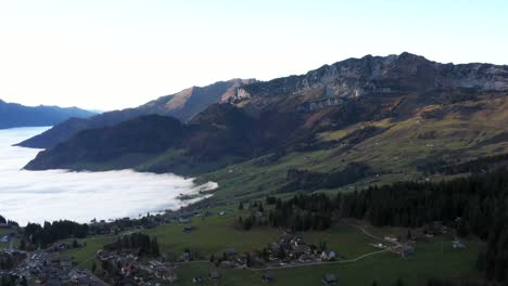 ascending shot of clouds coming up the leistchamm mountain up towards amden village