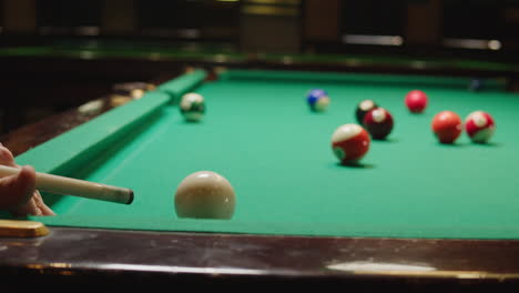 playing american billiard poule close-up. colorful balls on green billiards table .billiard balls with numbers on a pool table. billiards team sport.high quality 4k footage