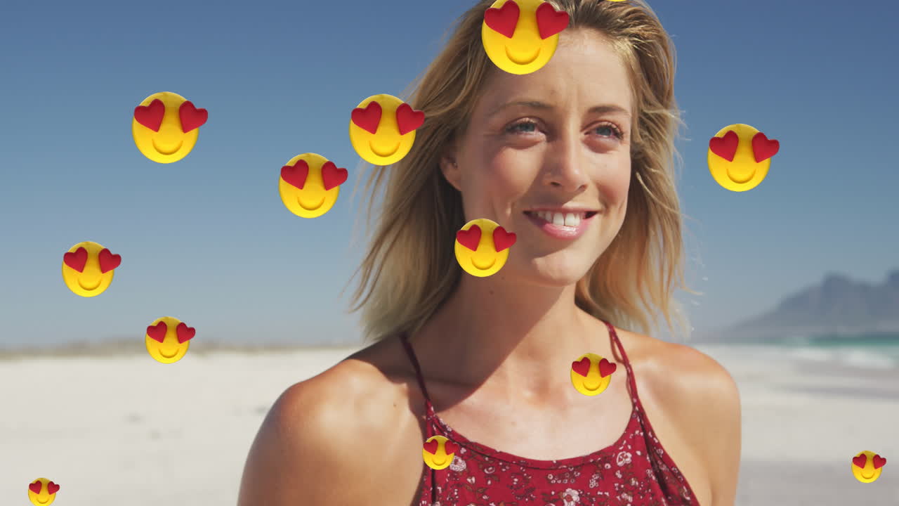 animación de emojis de amor de corazón rojo iconos digitales sobre mujer sonriente en la playa