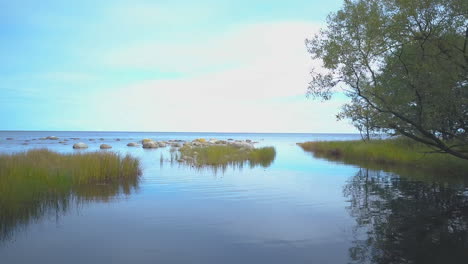 Droneshot-of-a-small-lagoon-with-a-fishing-boat-and-rocks