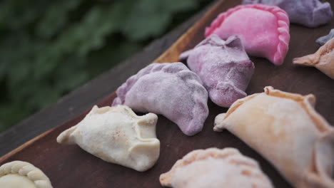 Close-up-view-of-typical-frozen-Argentine-empanadas-in-various-colors-and-flavors