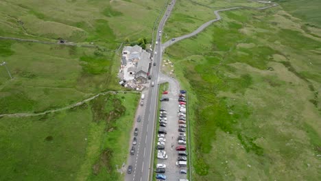 kirkstone pass busy road a592 summit on summer day with car park full and old kirkstone inn. lake district, cumbria, uk