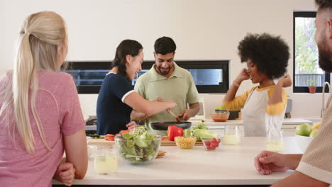 friends preparing meal together in kitchen, enjoying cooking and fresh ingredients