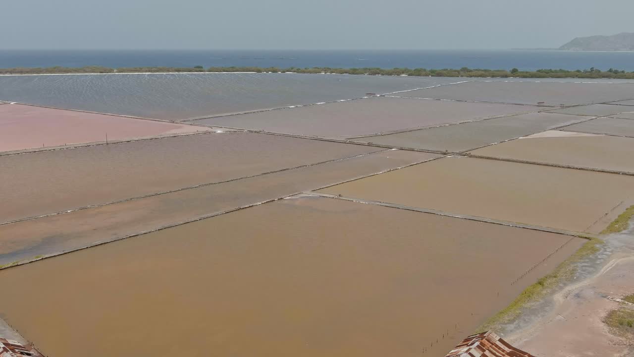 Salt pans and mines at Las Salinas with sea in background, Bani in Dominican Republic. Aerial forward