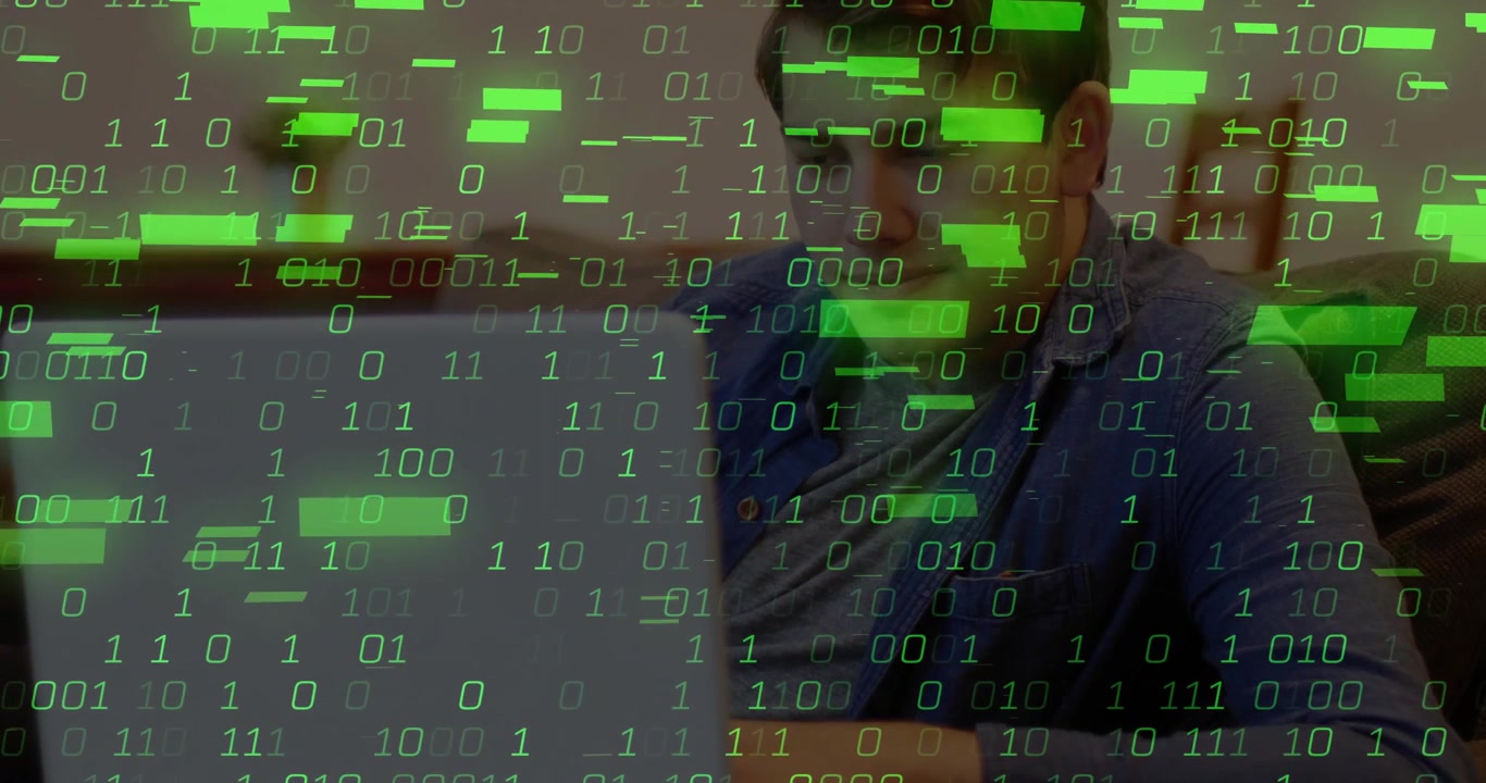 Man opening laptop and typing while testing software, green binary overlay intensifying across sofa