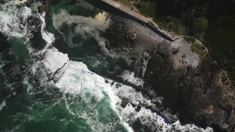 vista de drones de arriba hacia abajo de la piscina de marea y la costa rocosa en una ciudad de playa
